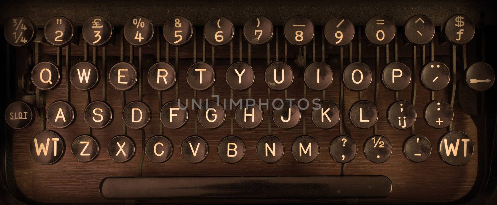 Close up of a dirty vintage typewriter, warm filter