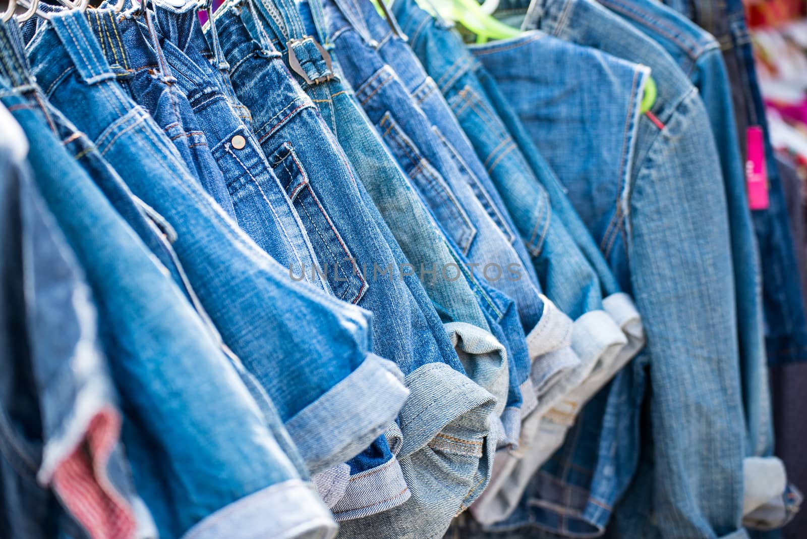 jeans hanging on hangers