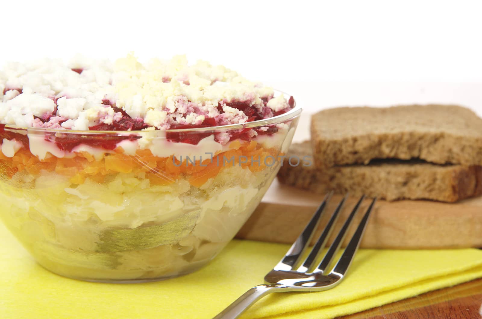 Russian traditional herring salad in glass bowl