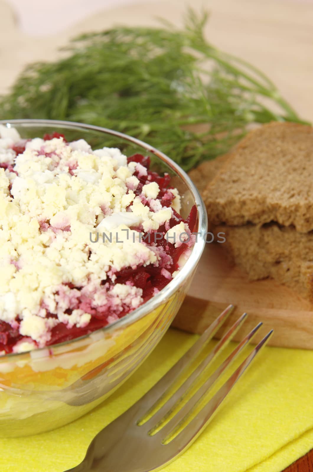 Russian traditional herring salad in glass bowl