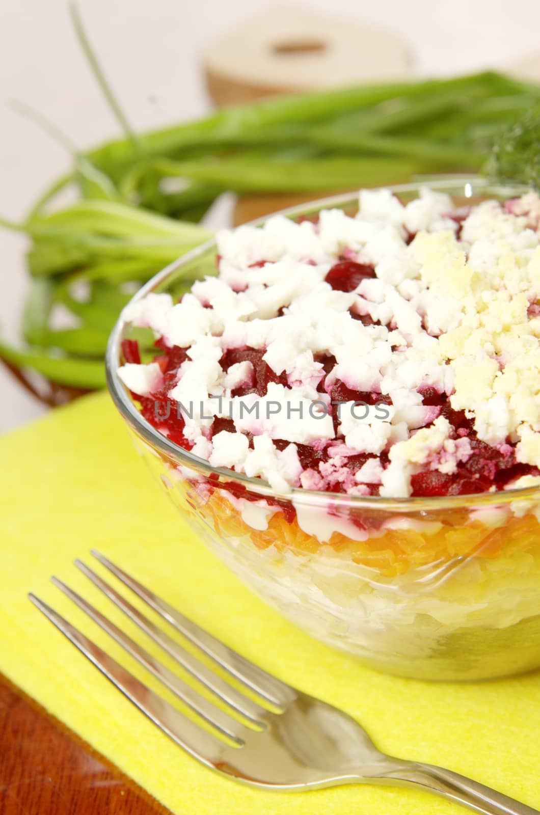 Russian traditional herring salad in glass bowl