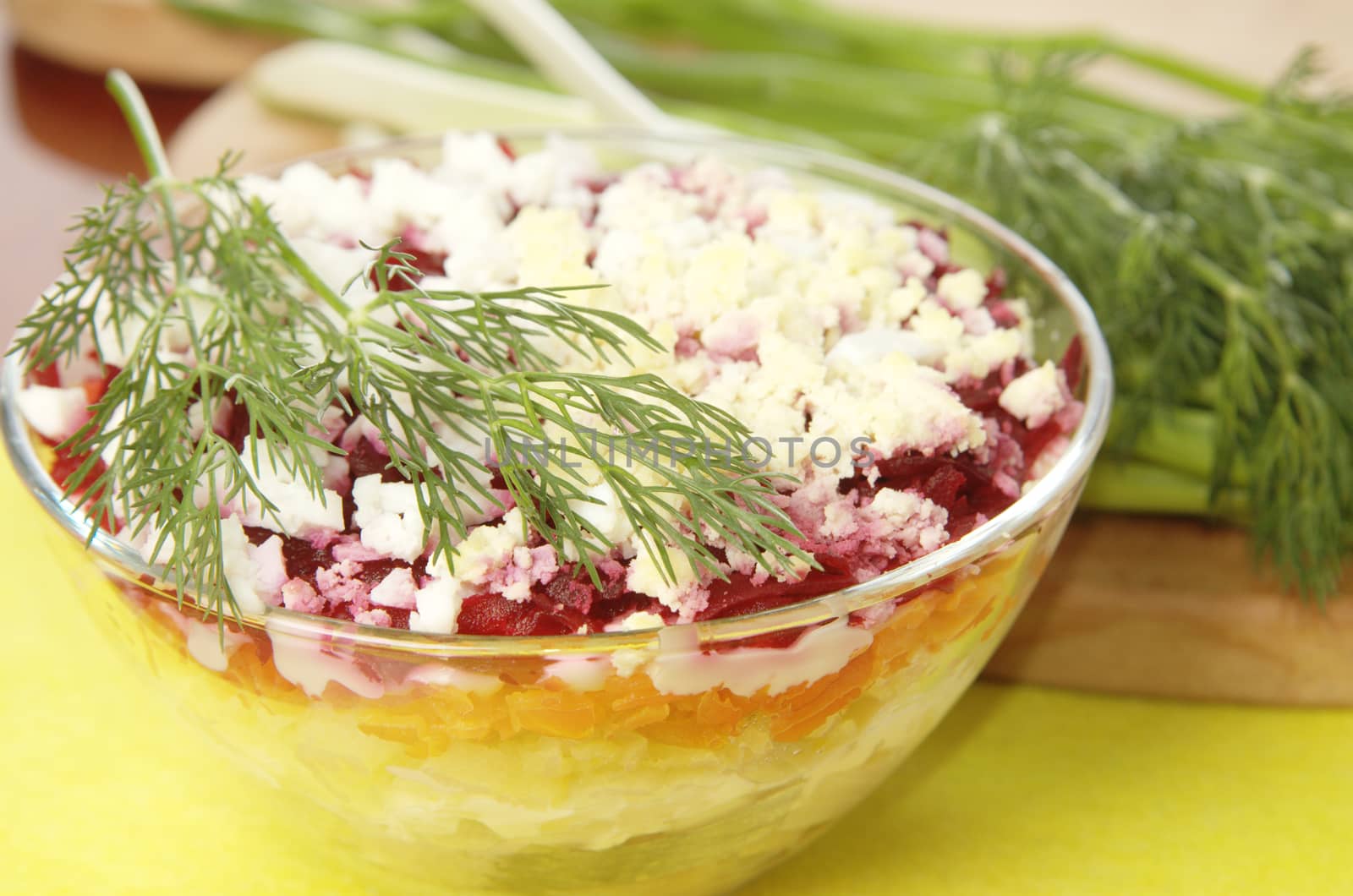 Russian traditional herring salad in glass bowl