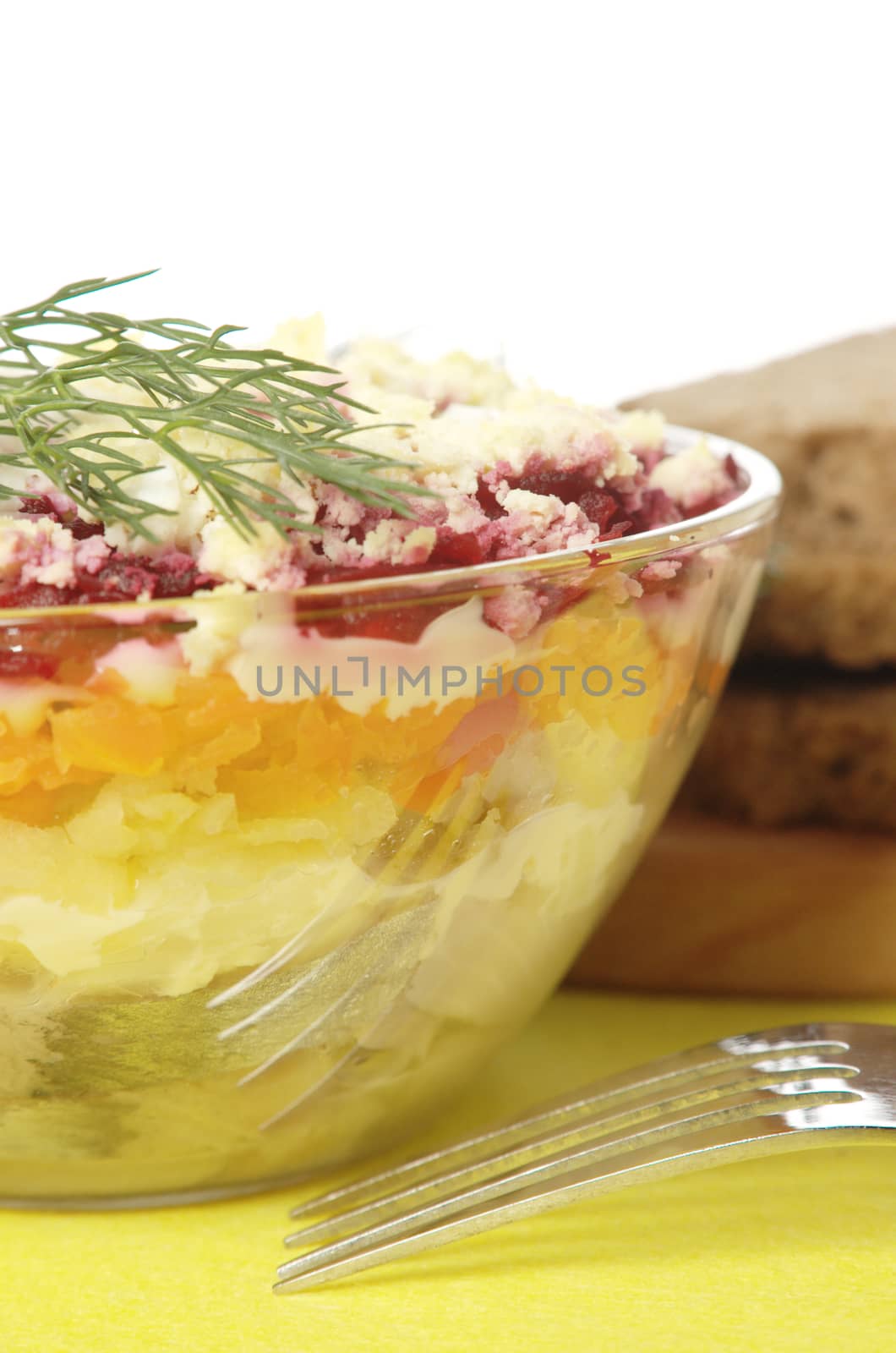 Russian traditional herring salad in glass bowl