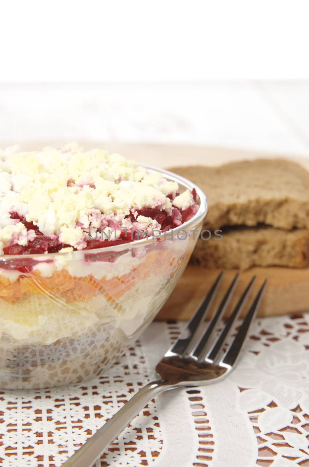 Russian traditional herring salad in glass bowl