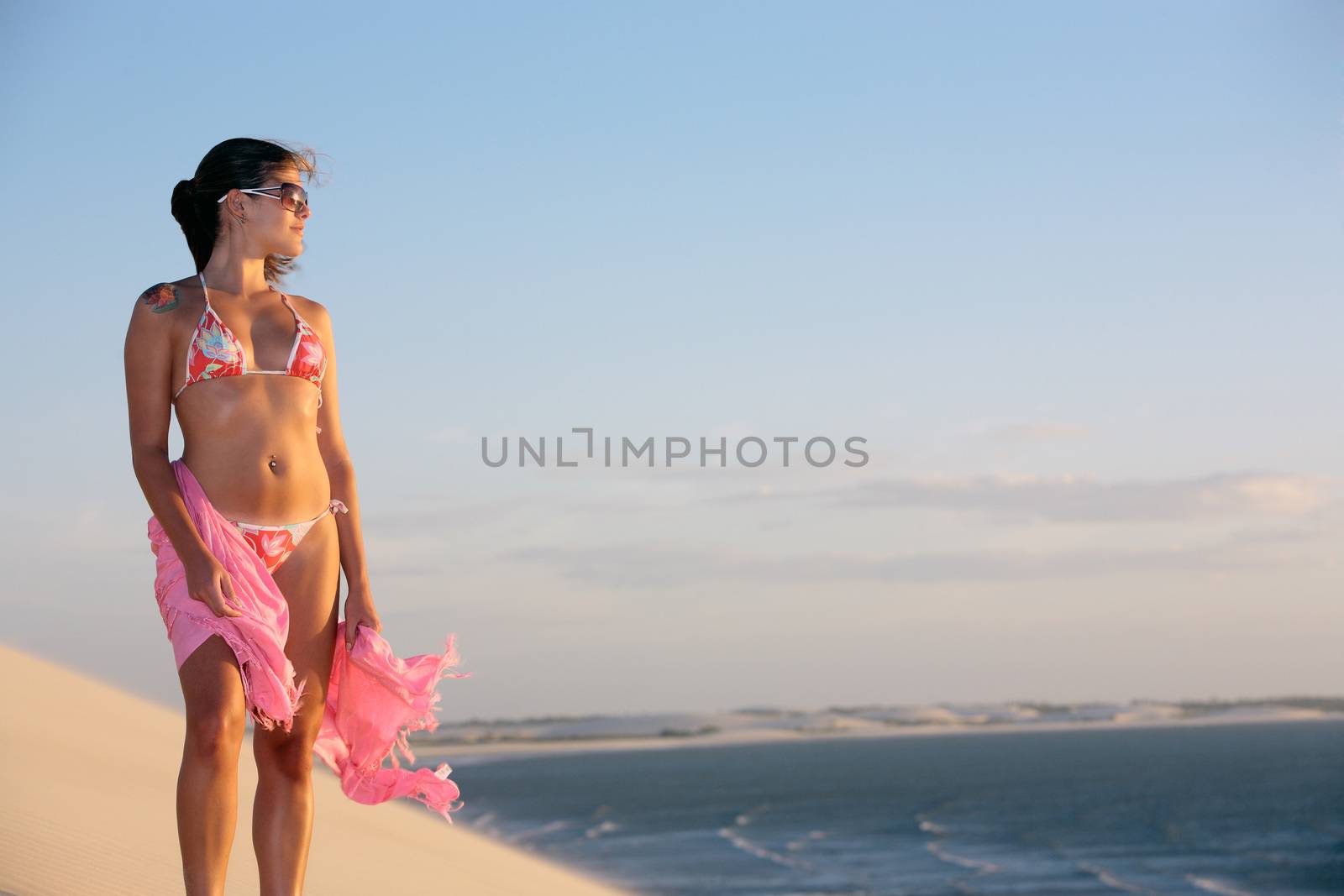 beautiful bikini dressed with a saron young Brazilian woman in jericoacoara at the sunset ceara state near fortaleza