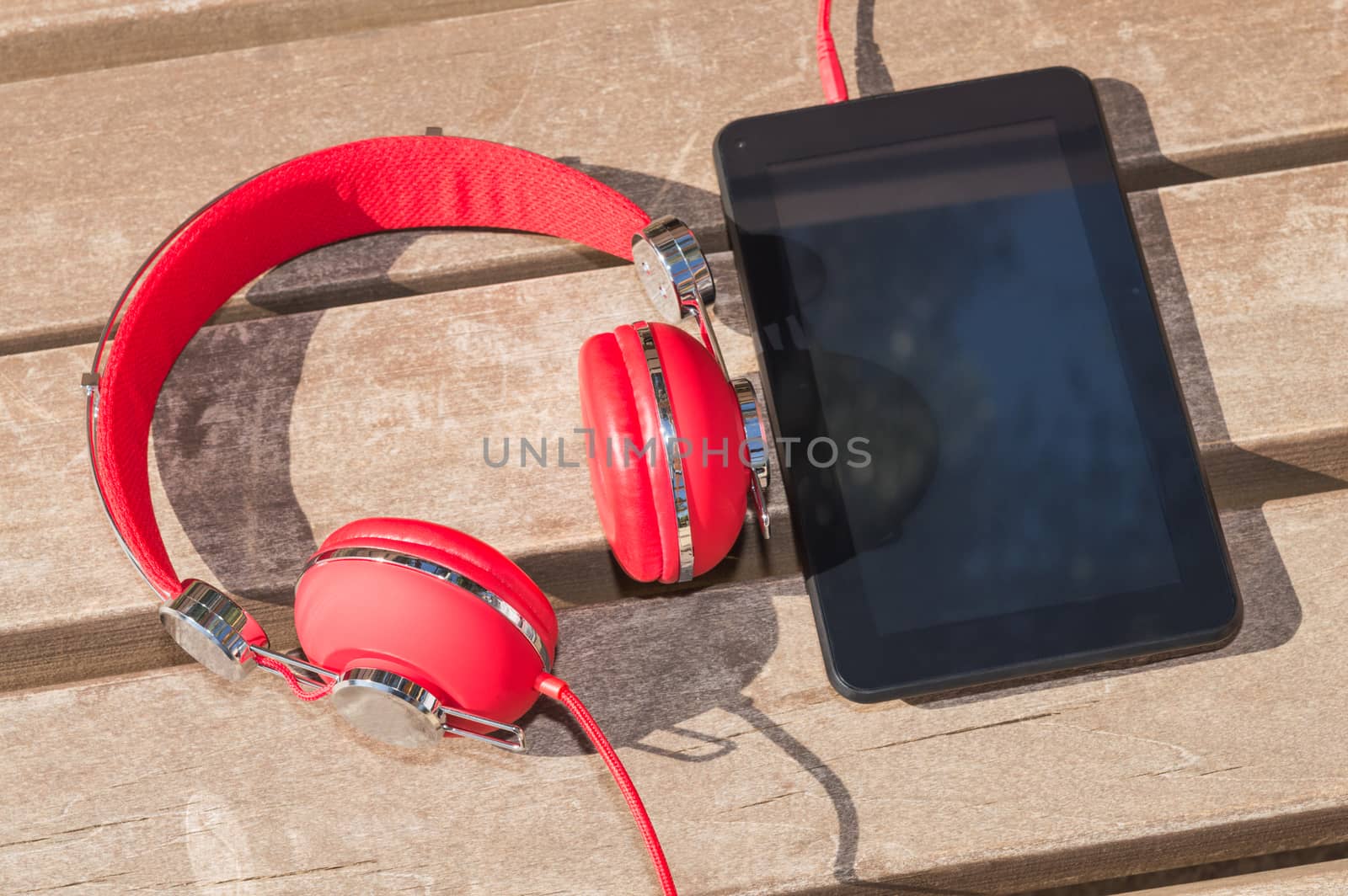 Distance interactive education with modern technology: tablet computer and red headphones 