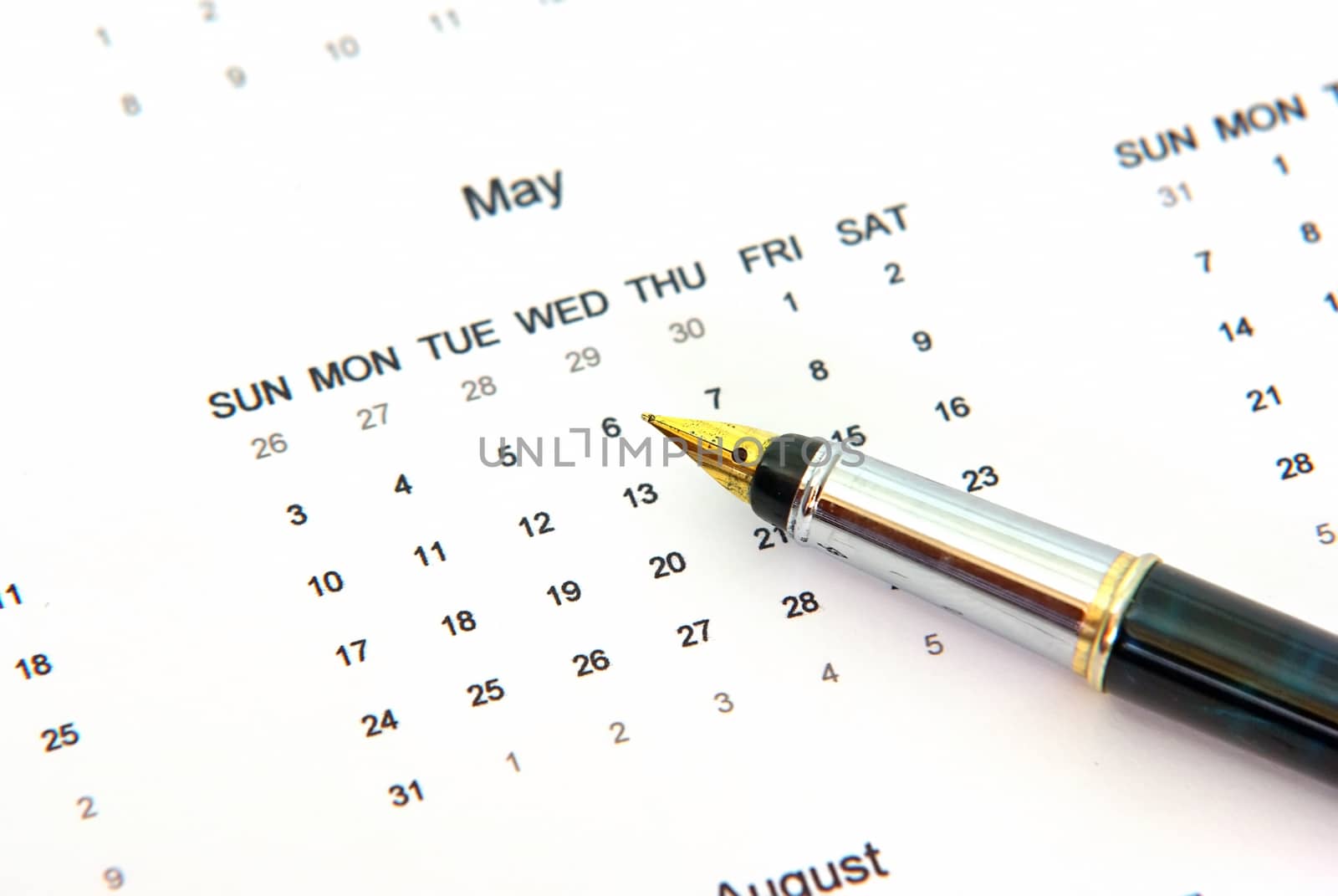 Close up of a calendar and a pen