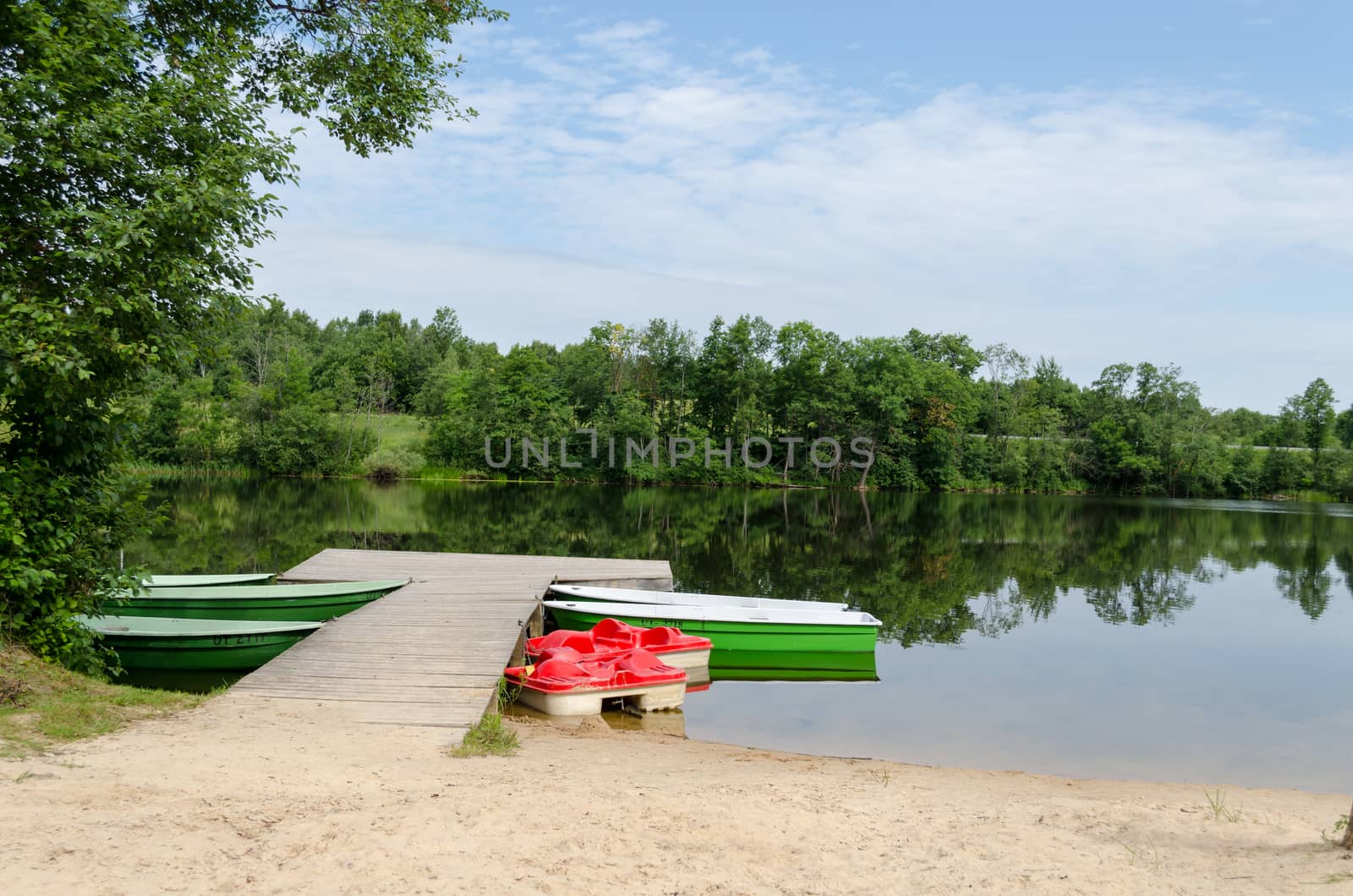 wooden footbridge and anchored boats water bikes by sauletas