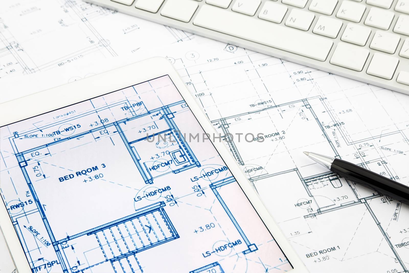 house blueprints and floor plan with tablet by vinnstock