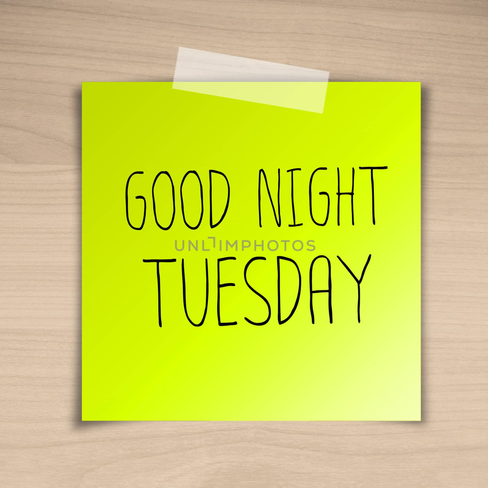 Good night tuesday sticky paper on brown wood background texture