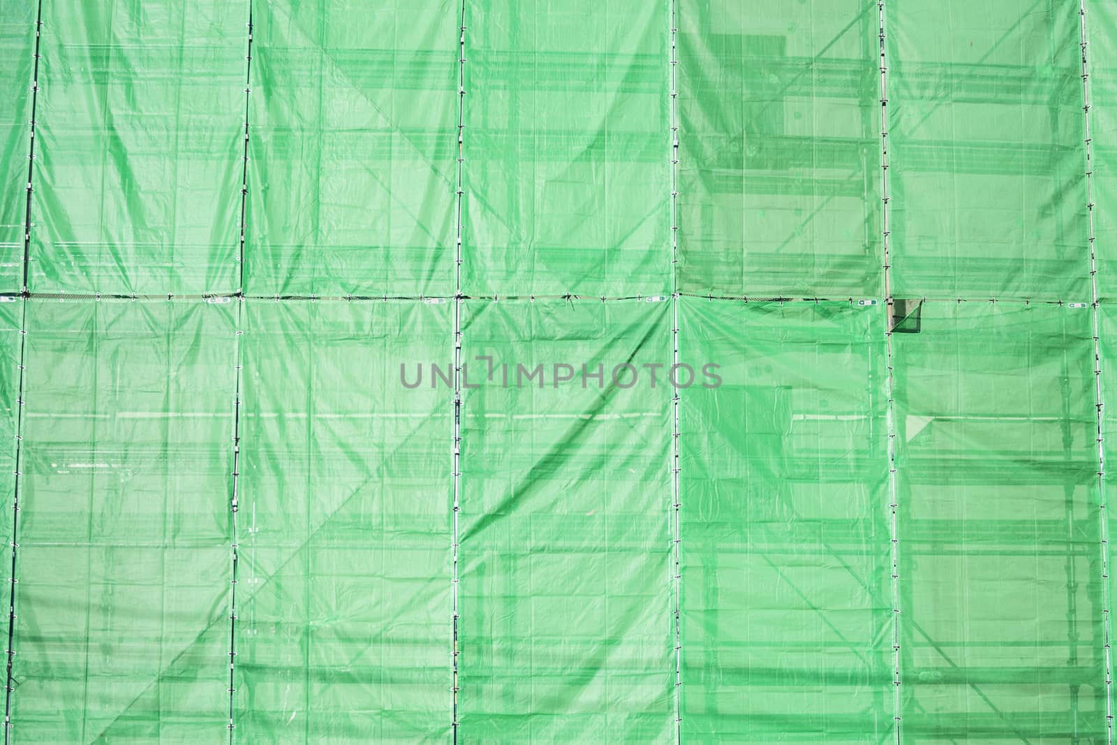Green cloth cover on building construction site by 2nix