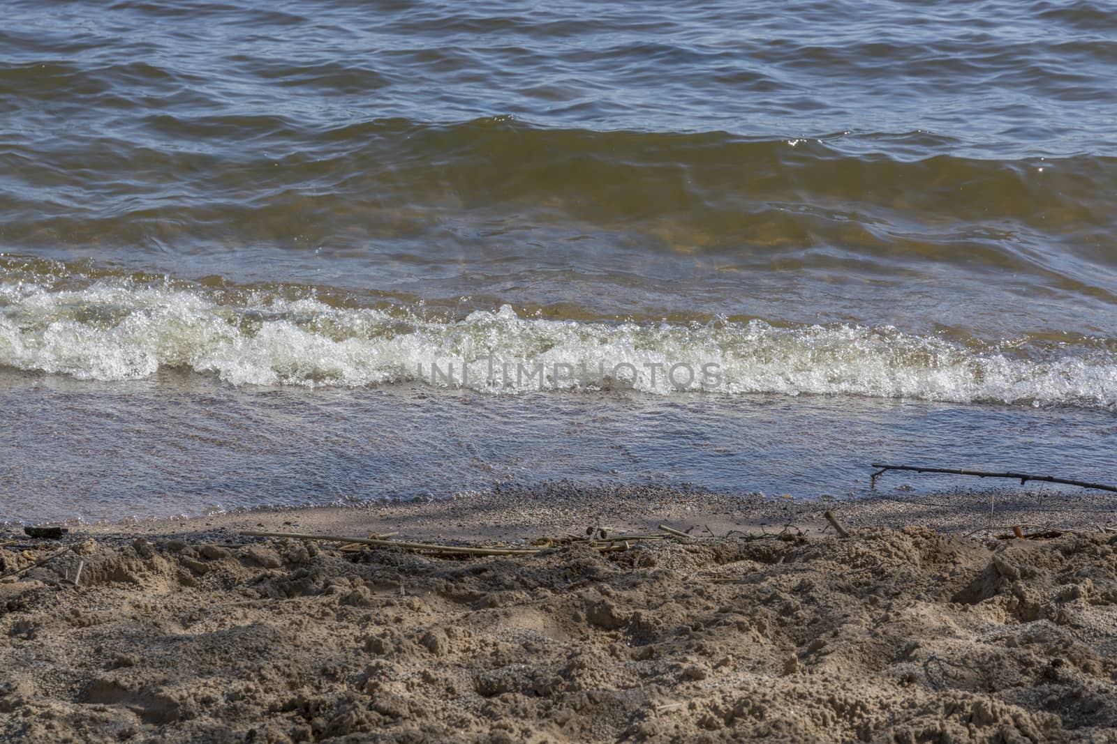 Beach detail with wave and sand, Stockholm, Sweden