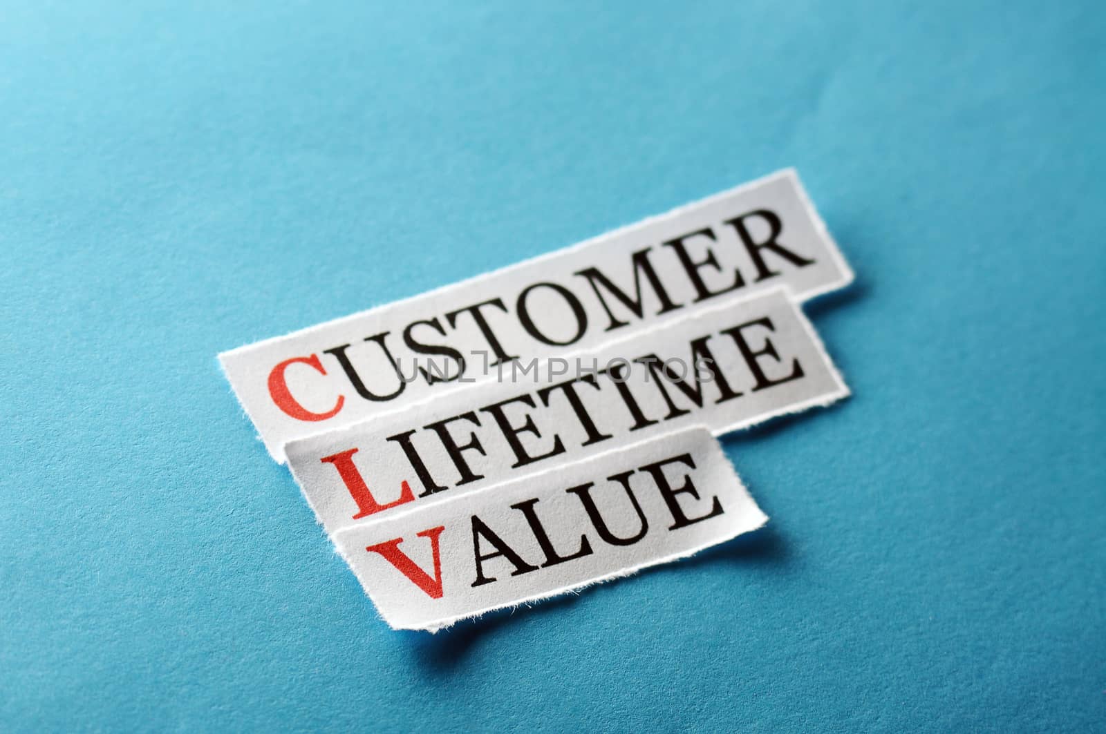 CLV customer lifetime value, words on cut paper hard light