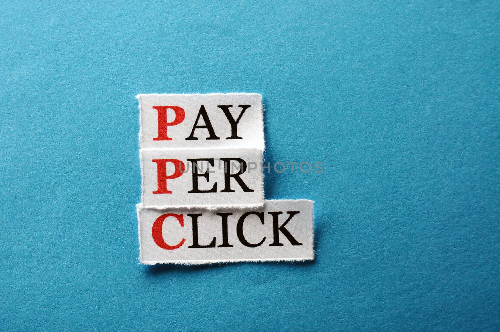 PPC Pay Per Click, words on cut paper hard light