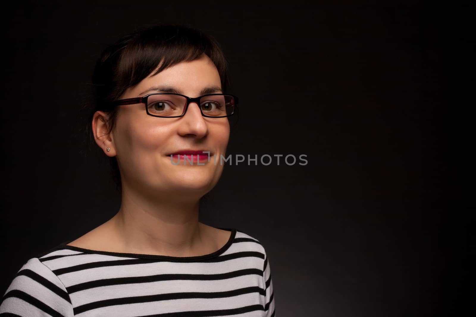 portrait of a stylish expressive woman with glasses in studio