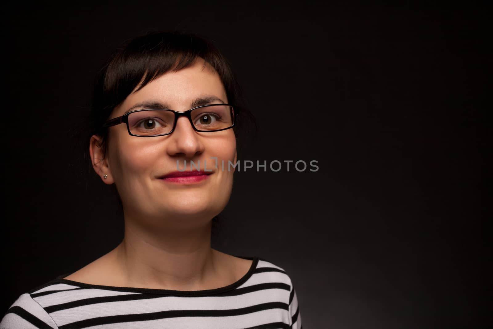 portrait of a stylish expressive woman with glasses in studio