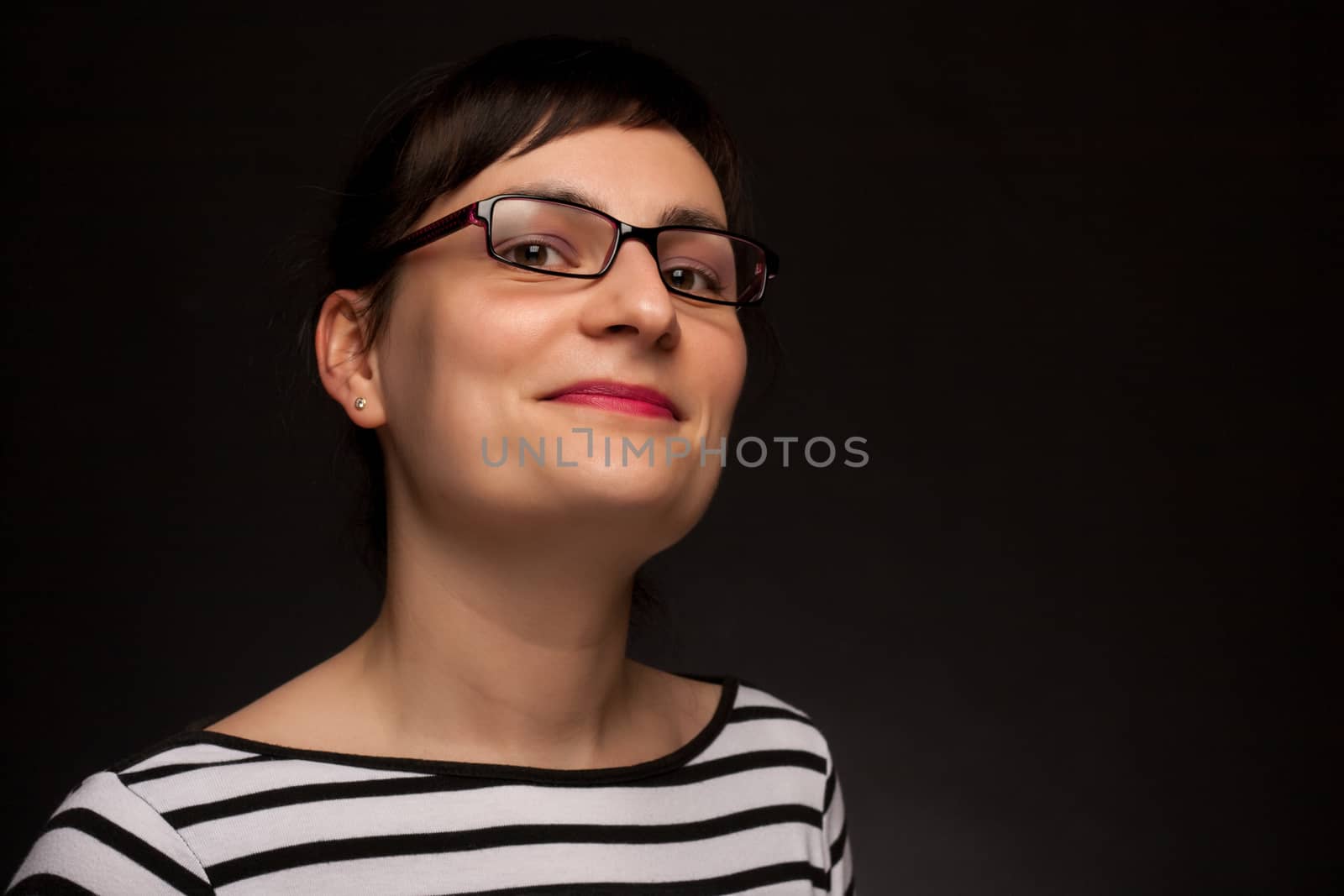 portrait of a stylish expressive woman with glasses in studio