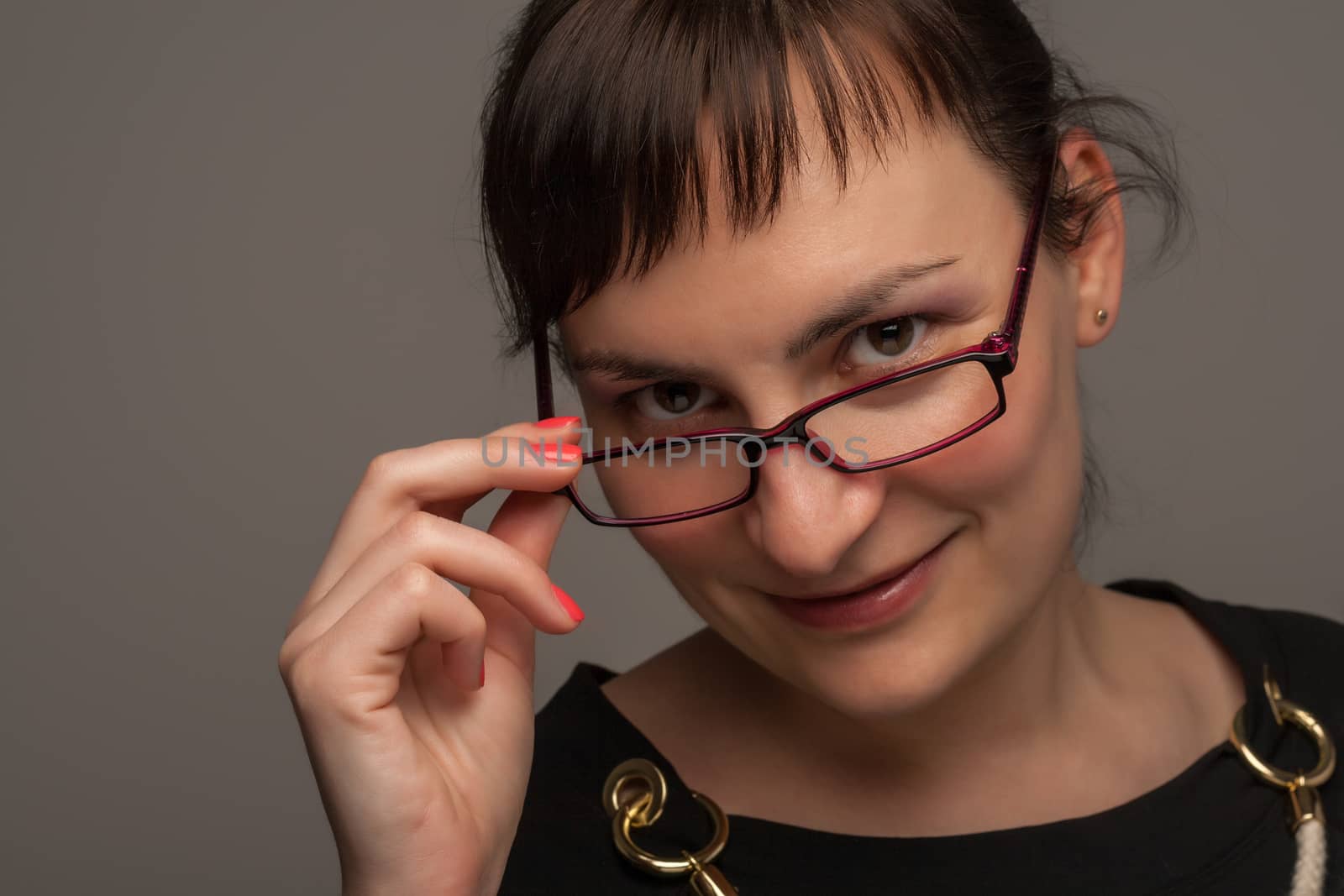 portrait of a stylish expressive woman with glasses in studio