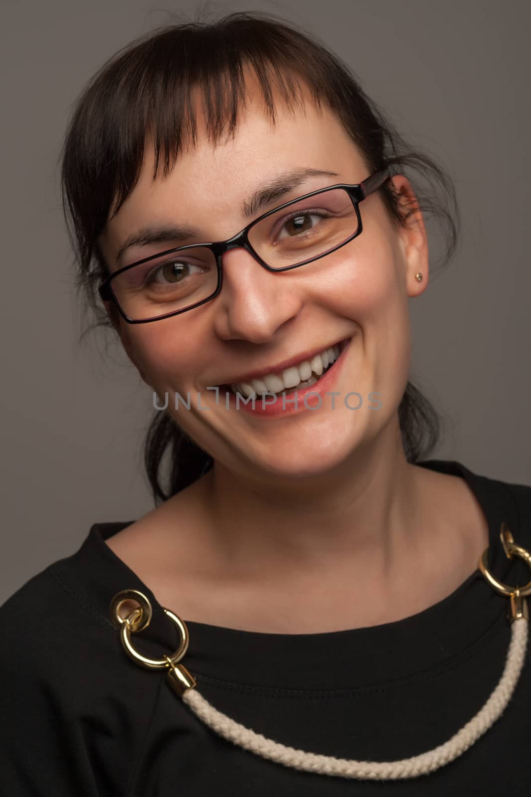 portrait of a stylish expressive woman with glasses in studio