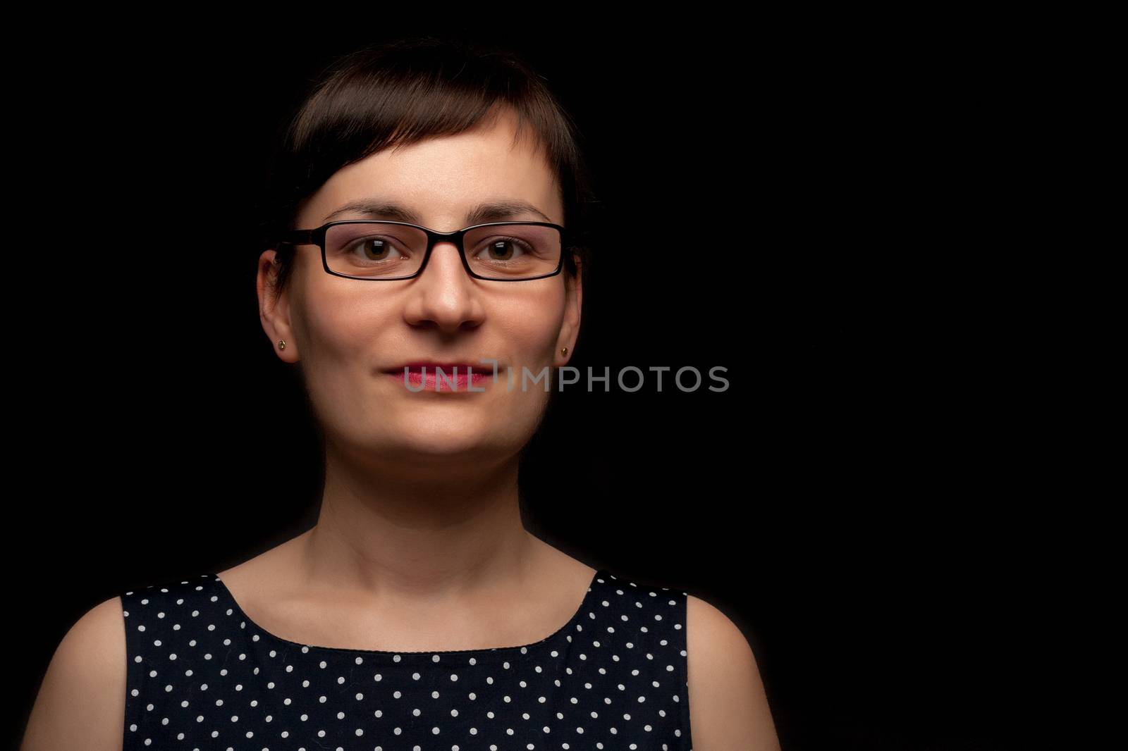 portrait of a stylish expressive woman with glasses in studio