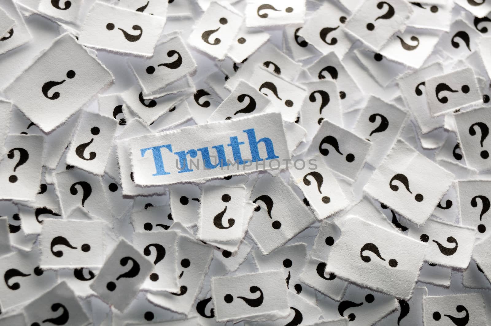 truth on question marks on white papers -hard light
