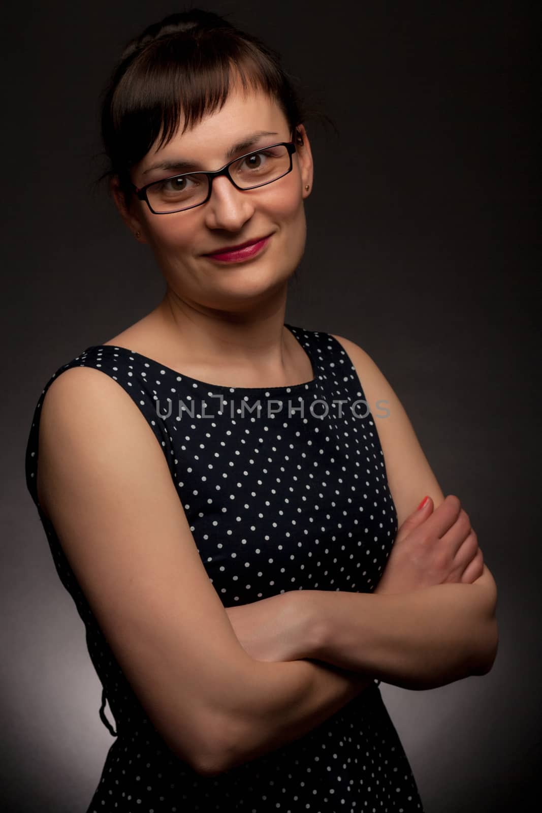 portrait of a stylish expressive woman with glasses in studio