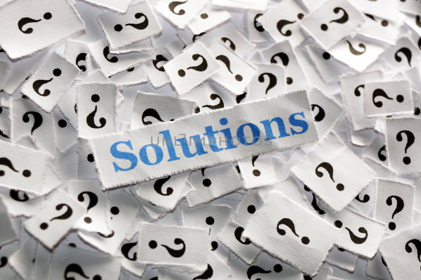 solutions on question marks on white papers -hard light