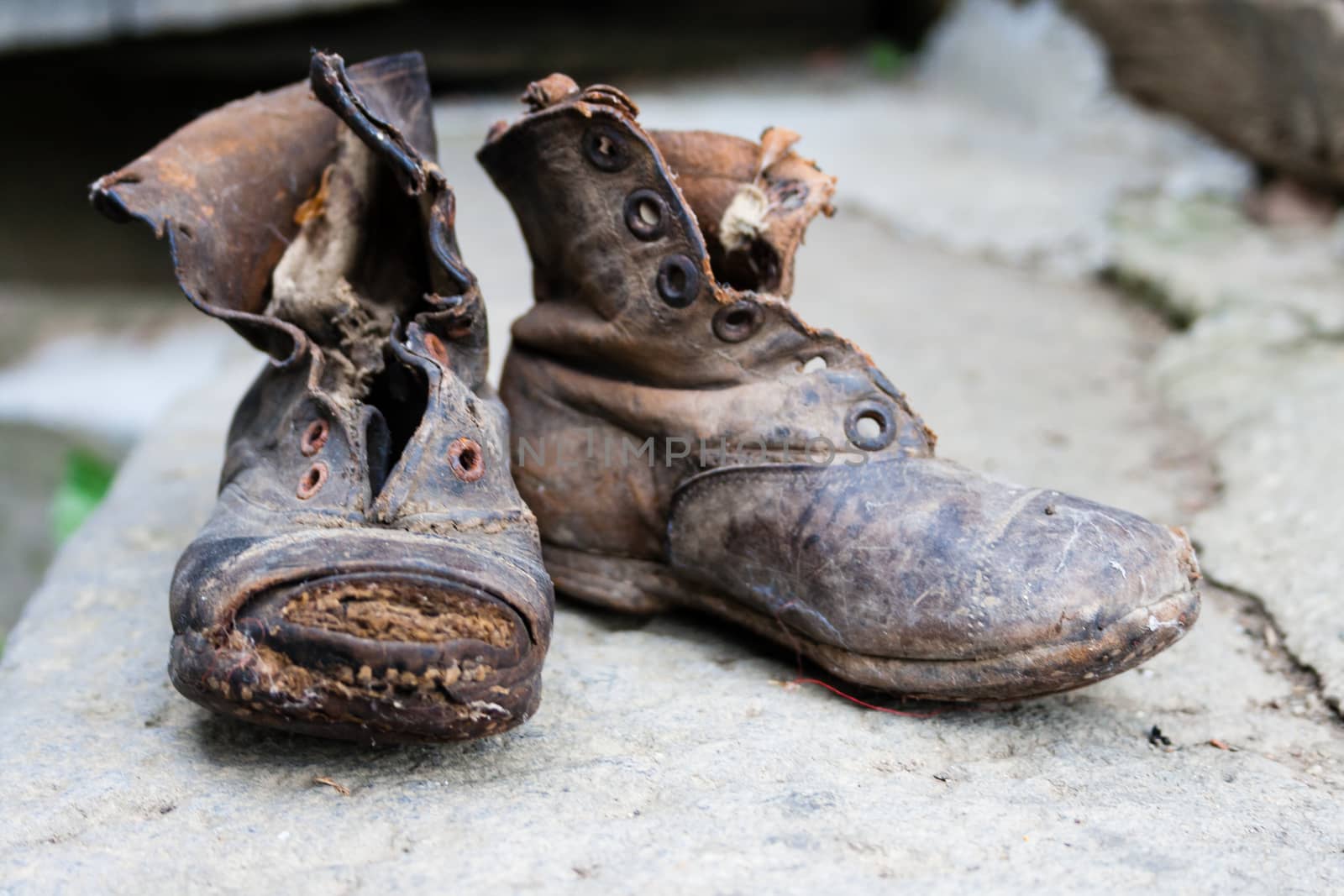two worn old and dirty leather boots