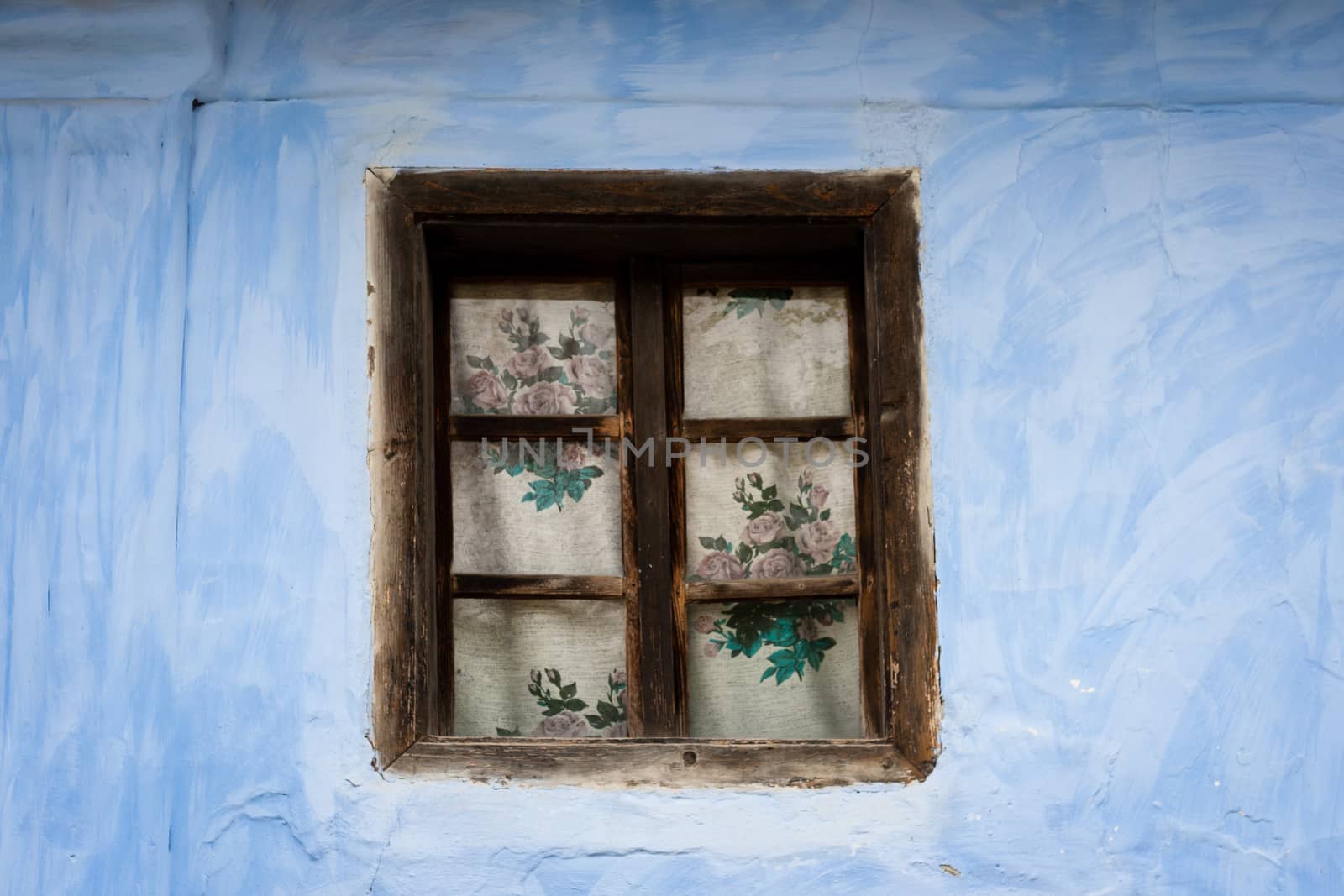 vintage, old brown wooden window on blue wall