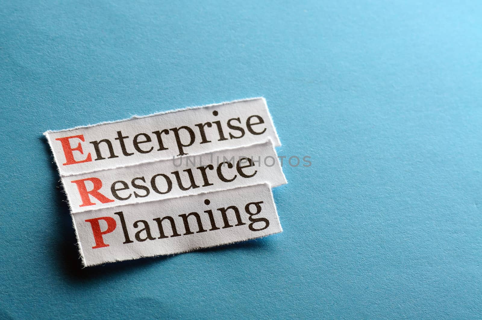 erp - enterprise resource planning on blue paper