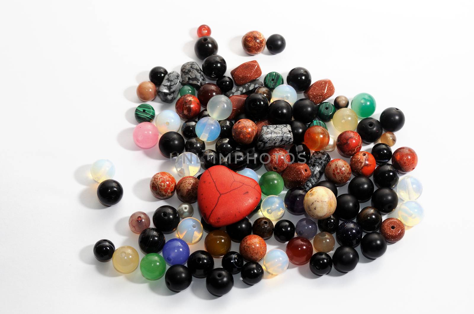 Mix of colorful polished gemstones balls  on the white background.