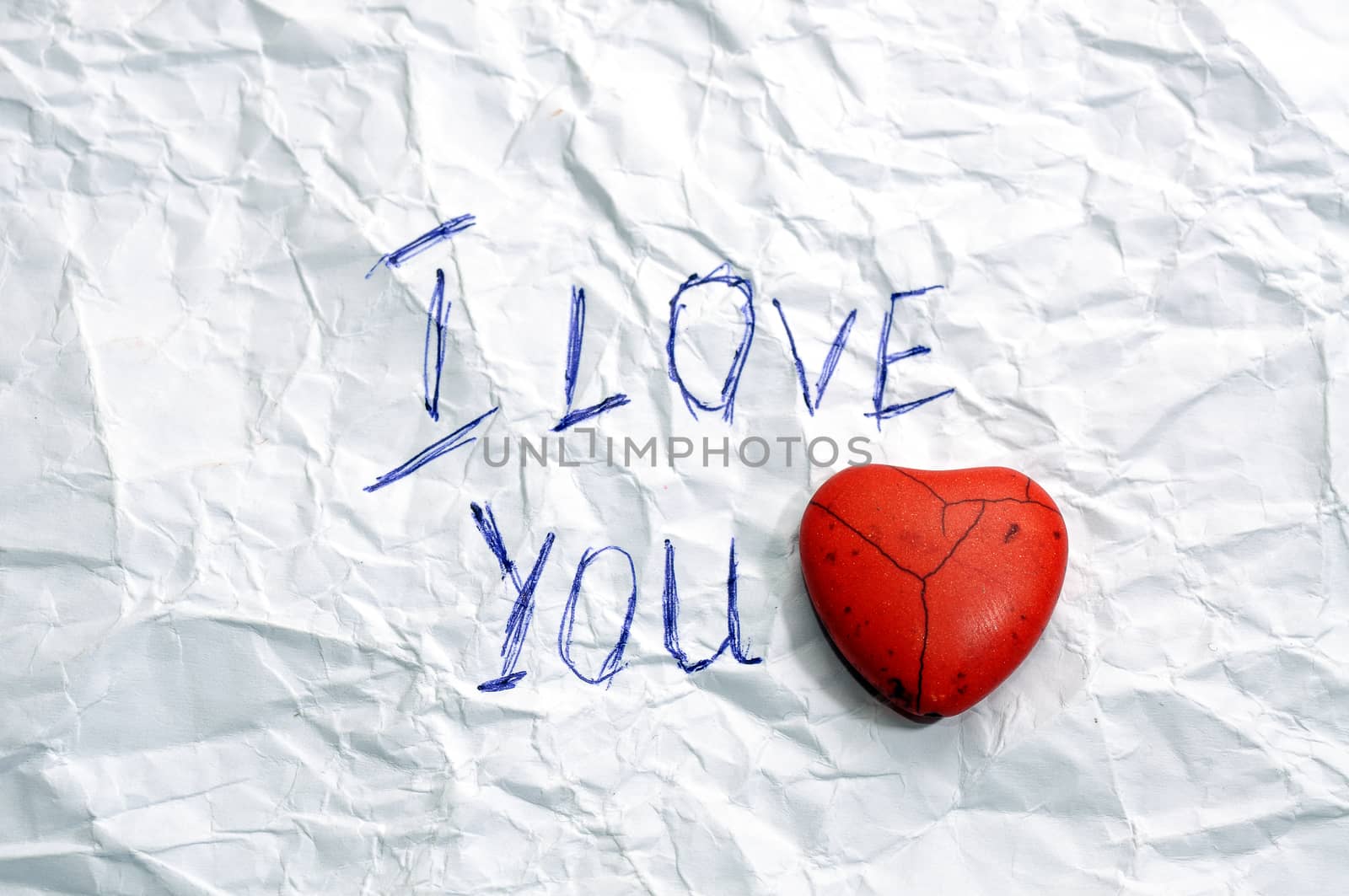 message I Love You on wrinkled paper and red  heart 