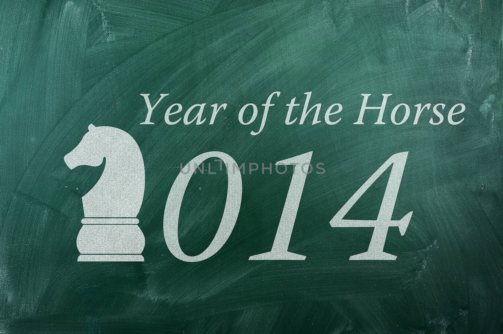 2014  year of the Horse on green ghalkboard