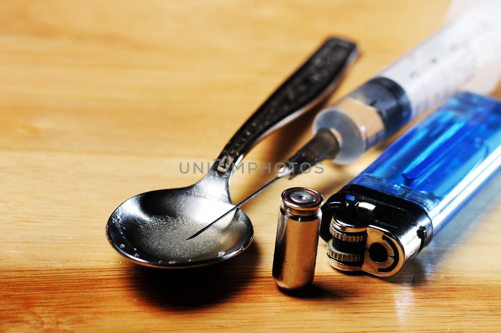 syringe, spoon ,bullet and lighter on the floor