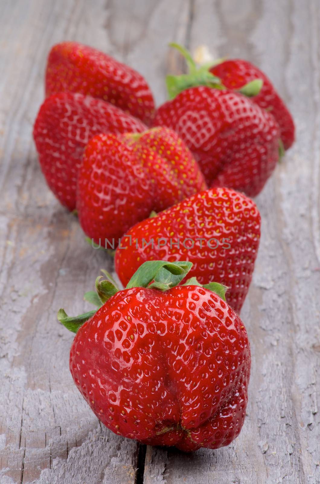 Big Fresh Ripe Strawberries closeup on Rustic Wooden background