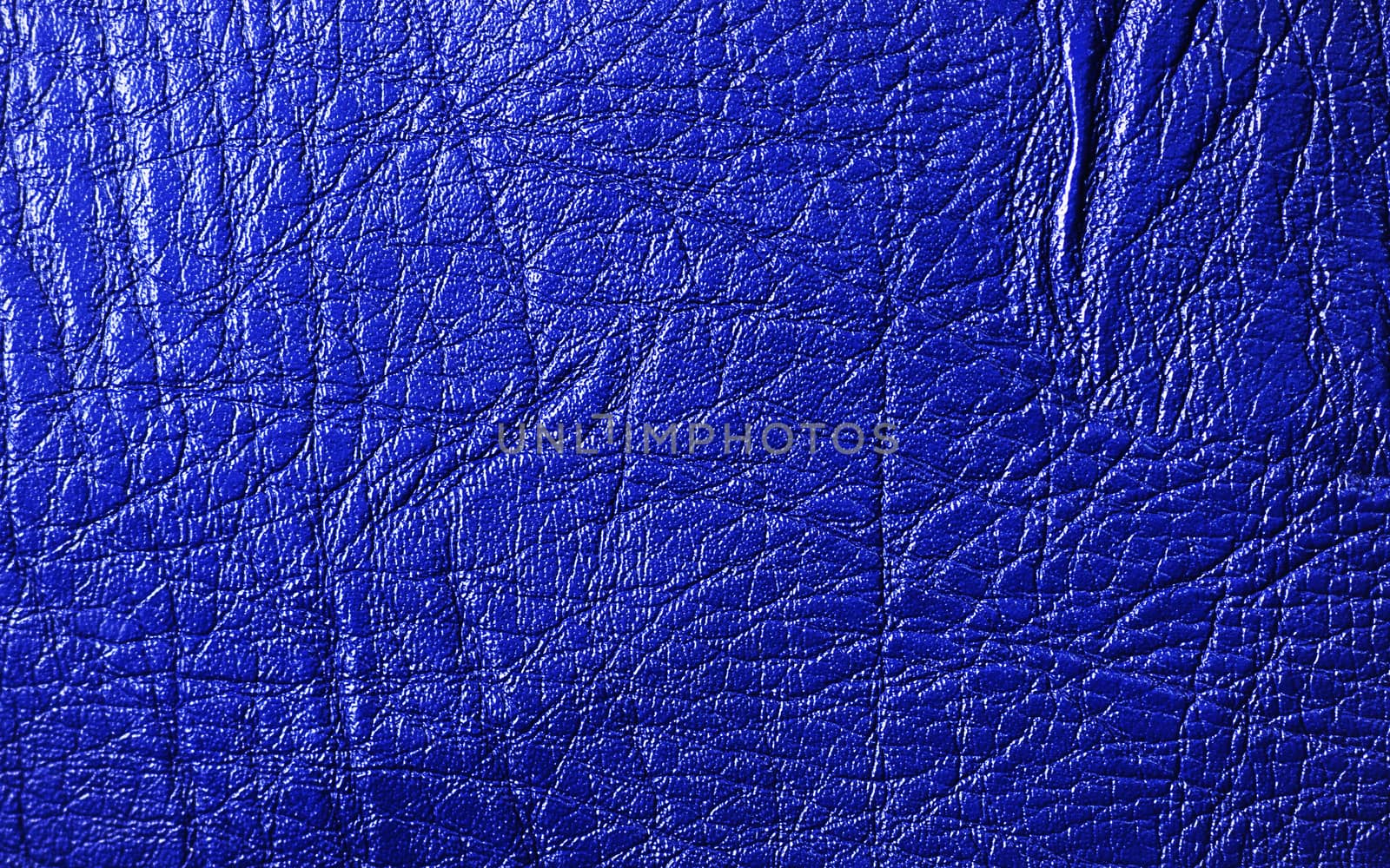 Blue vivid leather texture closeup, useful as background 