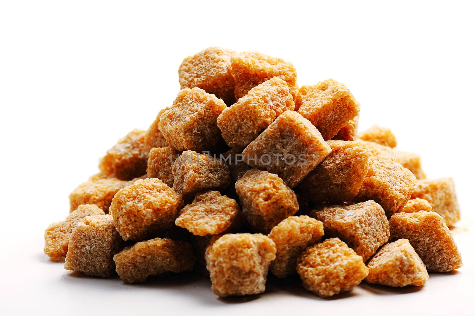 unrefined raw cane brown sugar cubes isolated on a white background