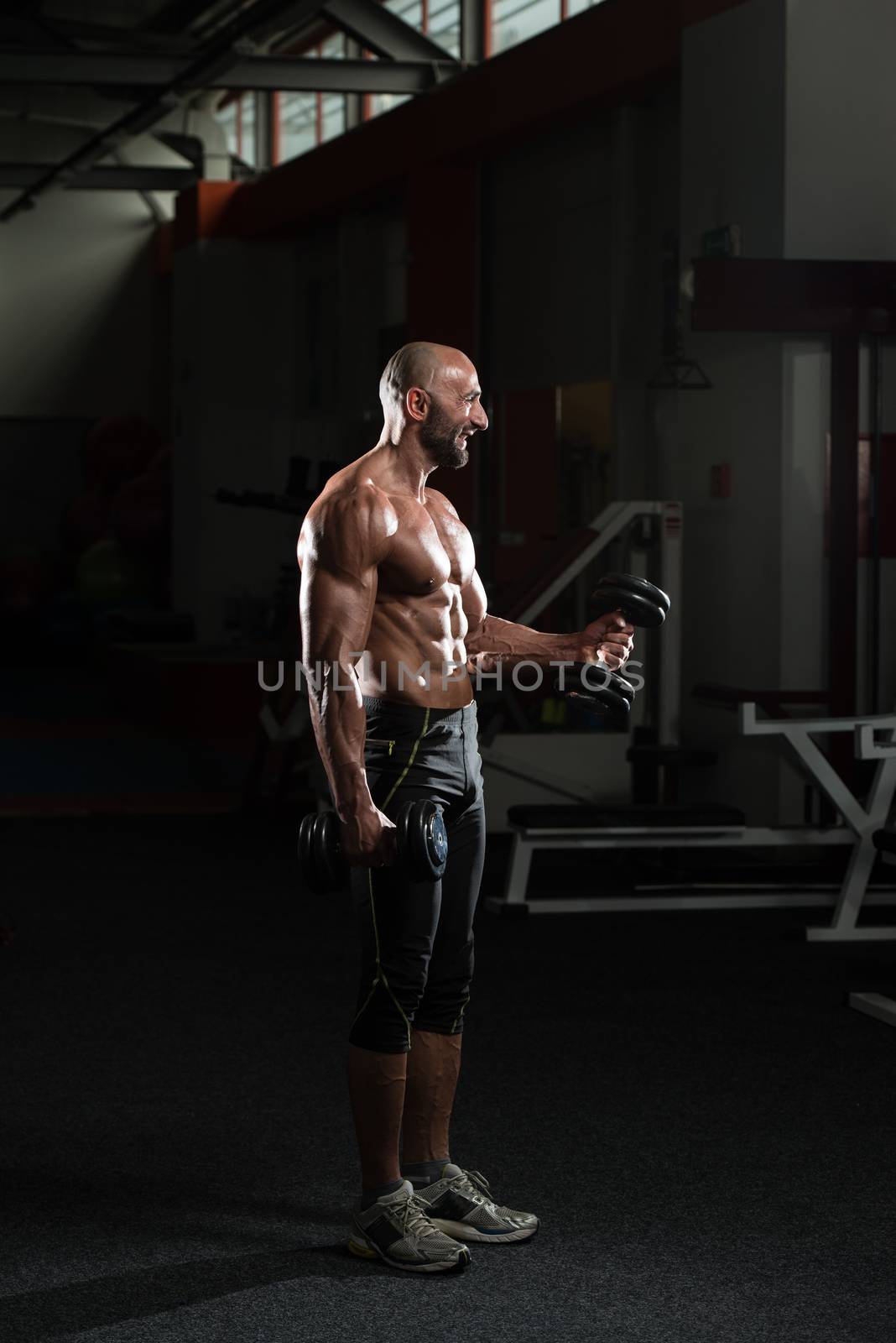 Mature Man Exercise With Dumbbell by JalePhoto