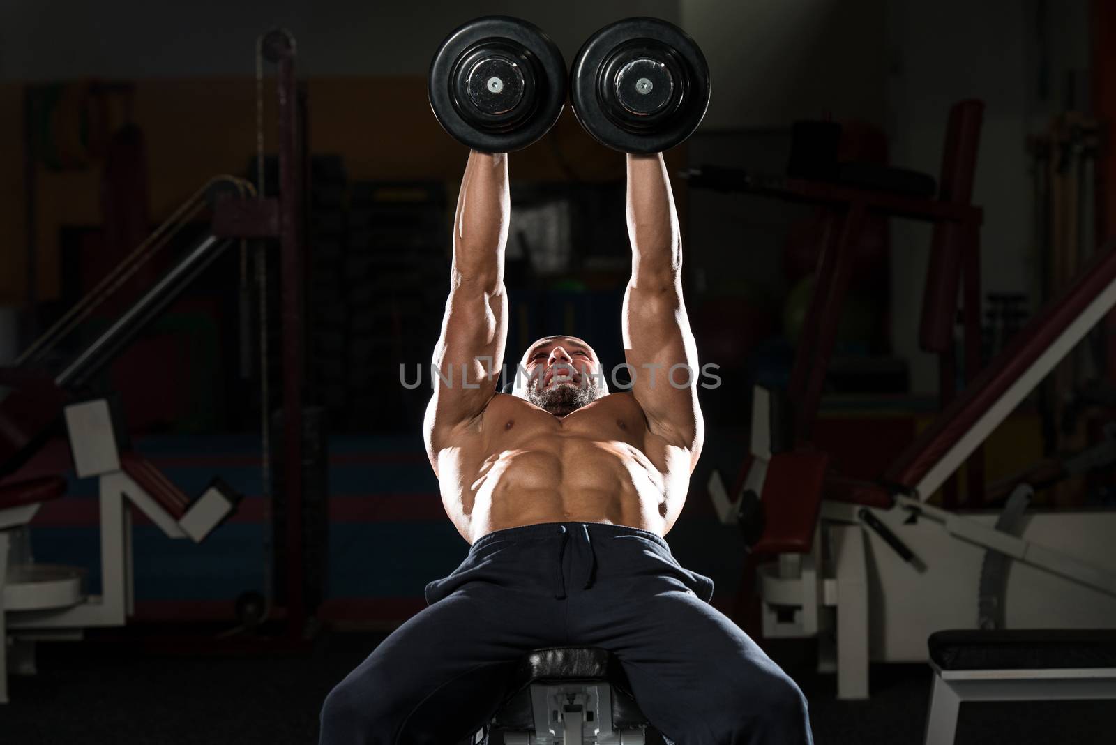 Mature Man Doing Dumbbell Incline Bench Press Workout by JalePhoto