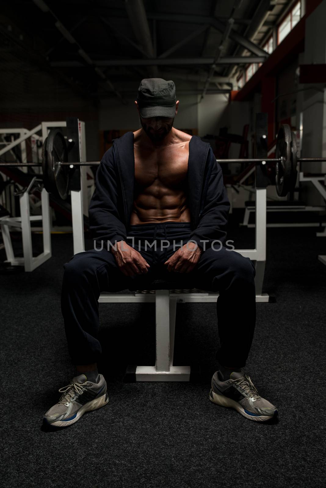 Portrait Of A Physically Fit Mature Man In A Healthy Club With Dramatic Lighting