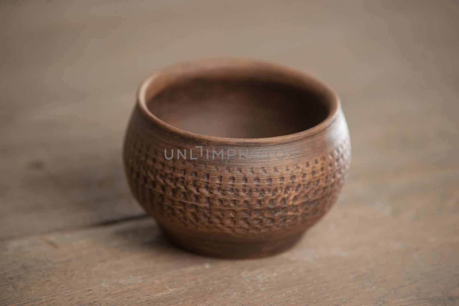 Traditional handcrafted dish of brown color on the table