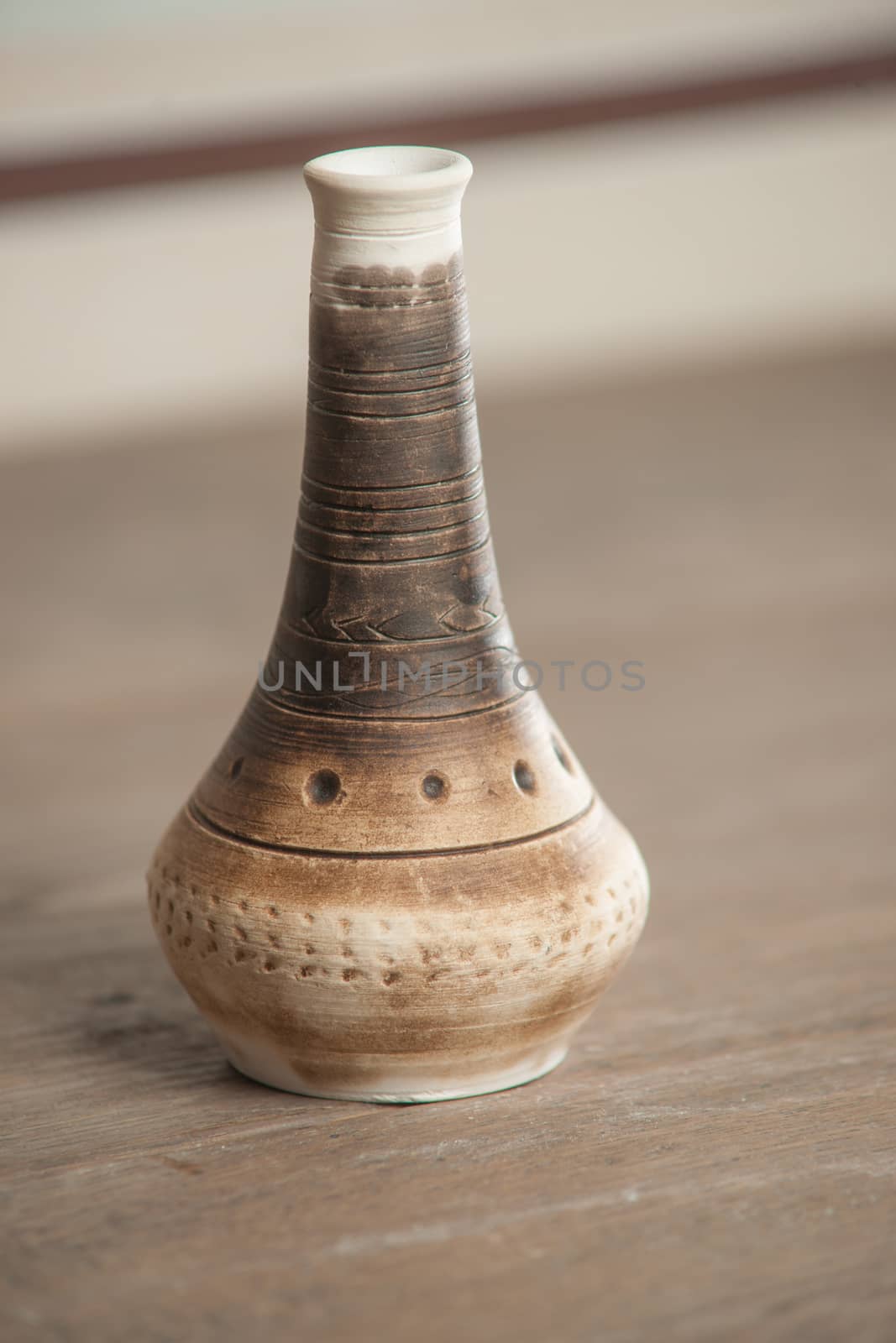 Traditional handcrafted vase of brown color on the table