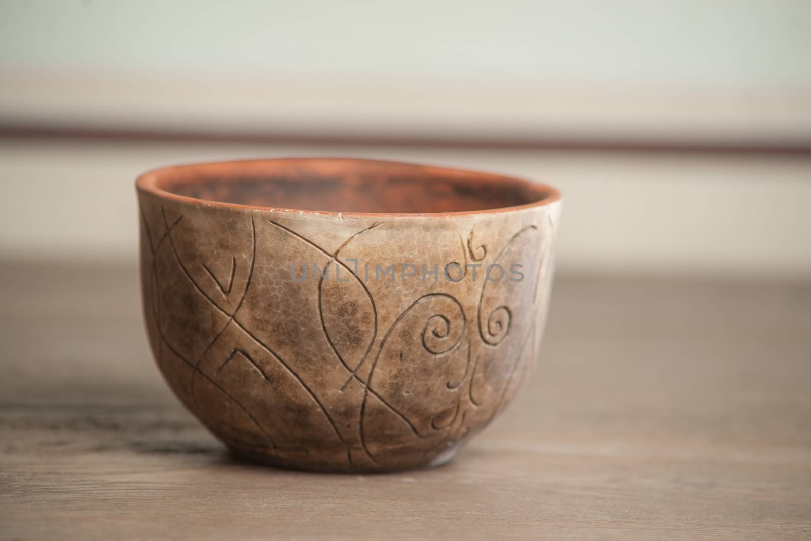 Traditional handcrafted dish of brown color on the table