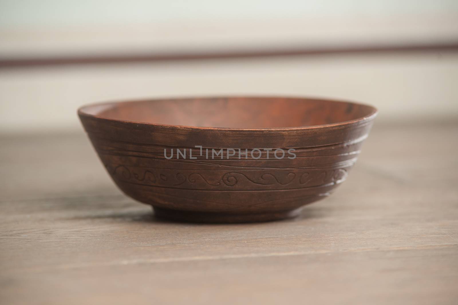 Traditional handcrafted dish of brown color on the table