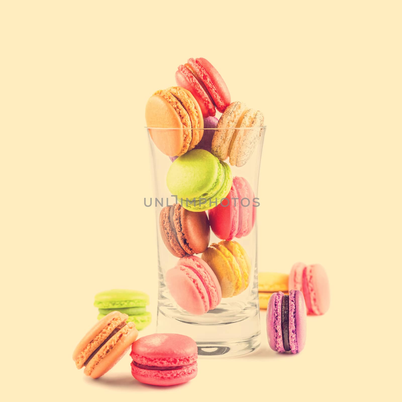 traditional french colorful macarons in a glass on vintage background