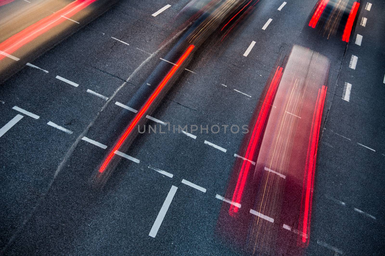 Motion blurred city road traffic (color toned  image)