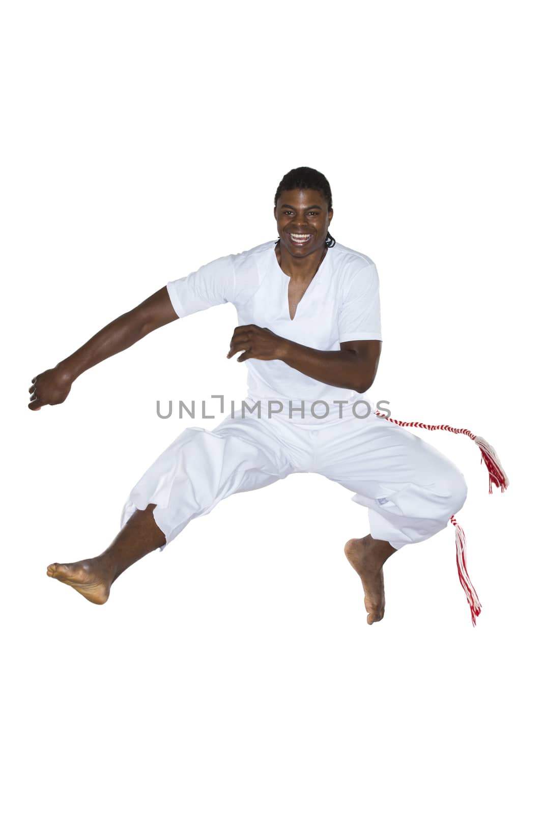 Capoeira, Brazilian Man jumping, dressed in white. by BrazilPhoto