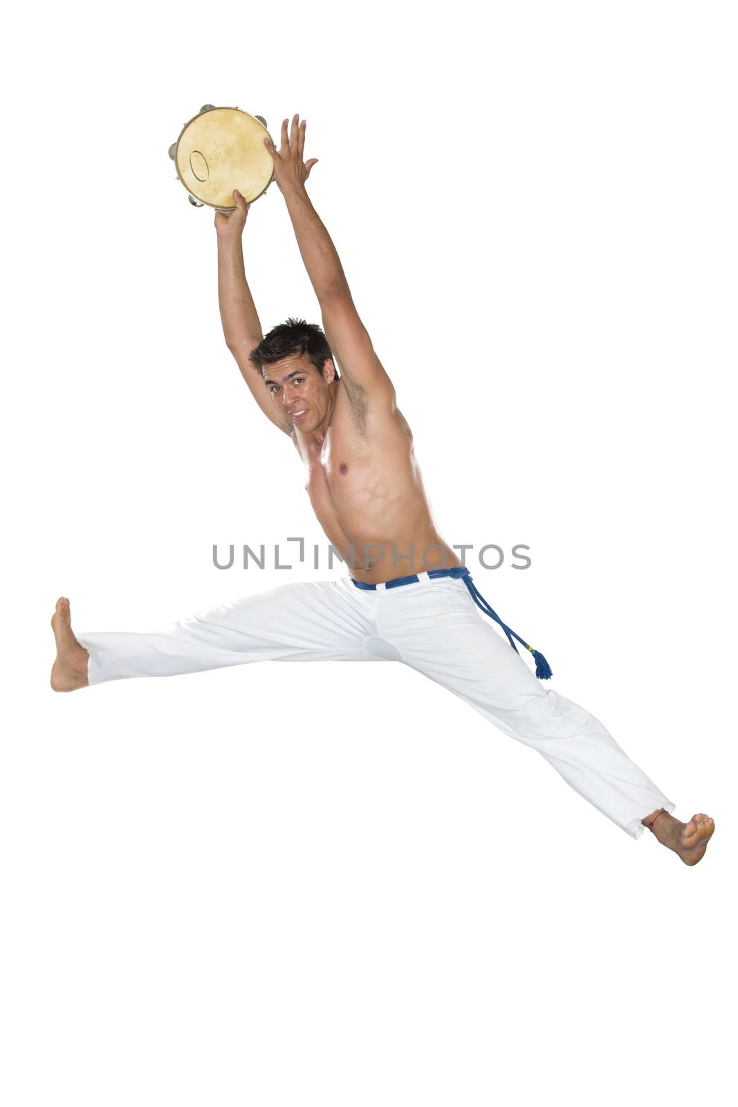 Capoeira, Brazilian Man jumping with tambourine by BrazilPhoto