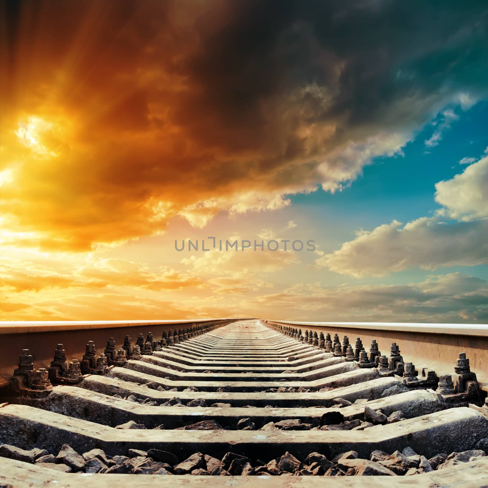 railway closeup to horizon under colored sky in sunset