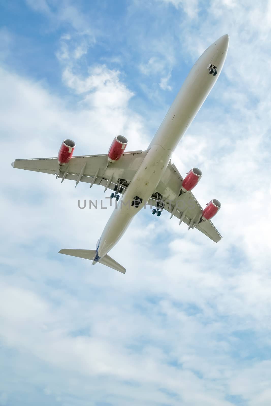 passenger jet on takeoff or landing against cloudy blue sky